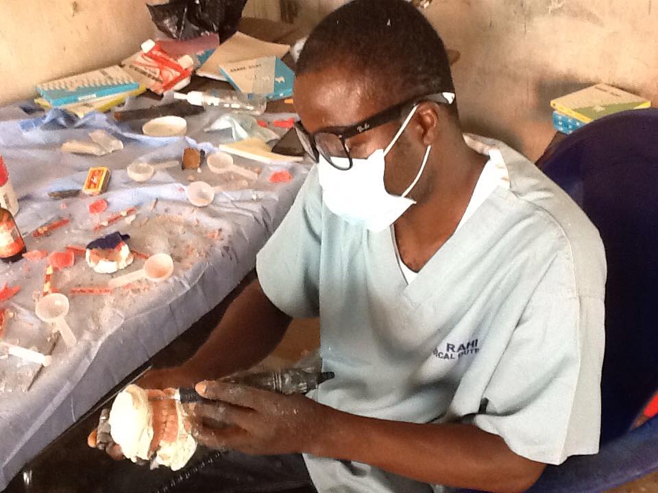 Dental technologist fabricating a denture