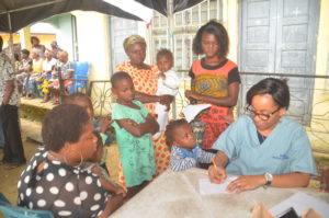 Doctor attending to Nursing mothers and children