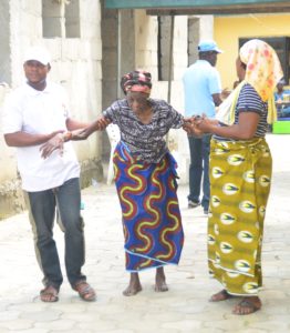 An old woman being assisted to the laboratory unit